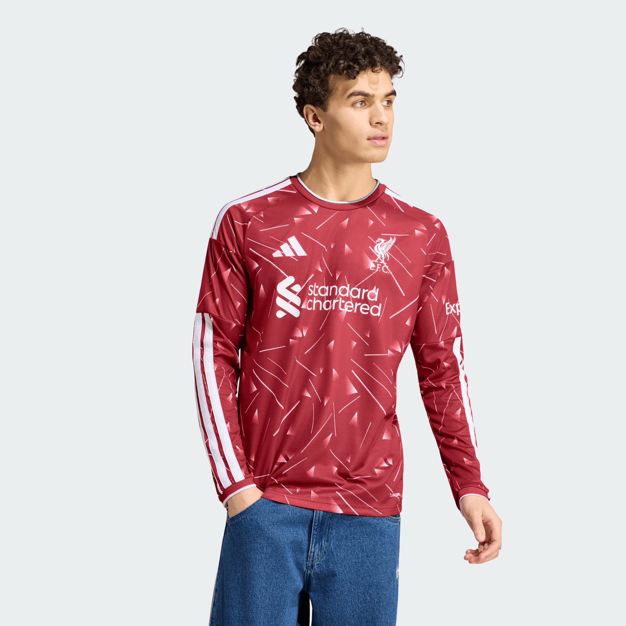 Person wearing a red sports jersey with visible branding on a light gray background